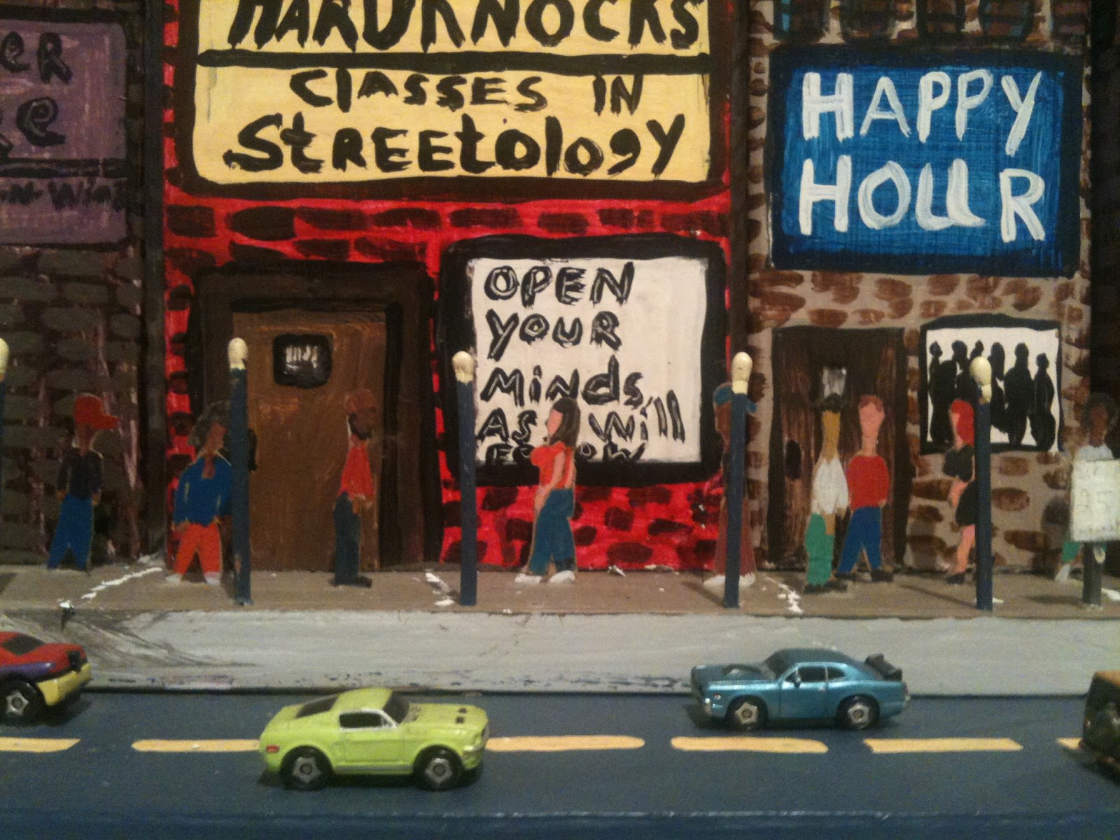 A painting of a street scene by Michelangelo Lovelace. A sign on one of the buildings says "classes in streetology". 