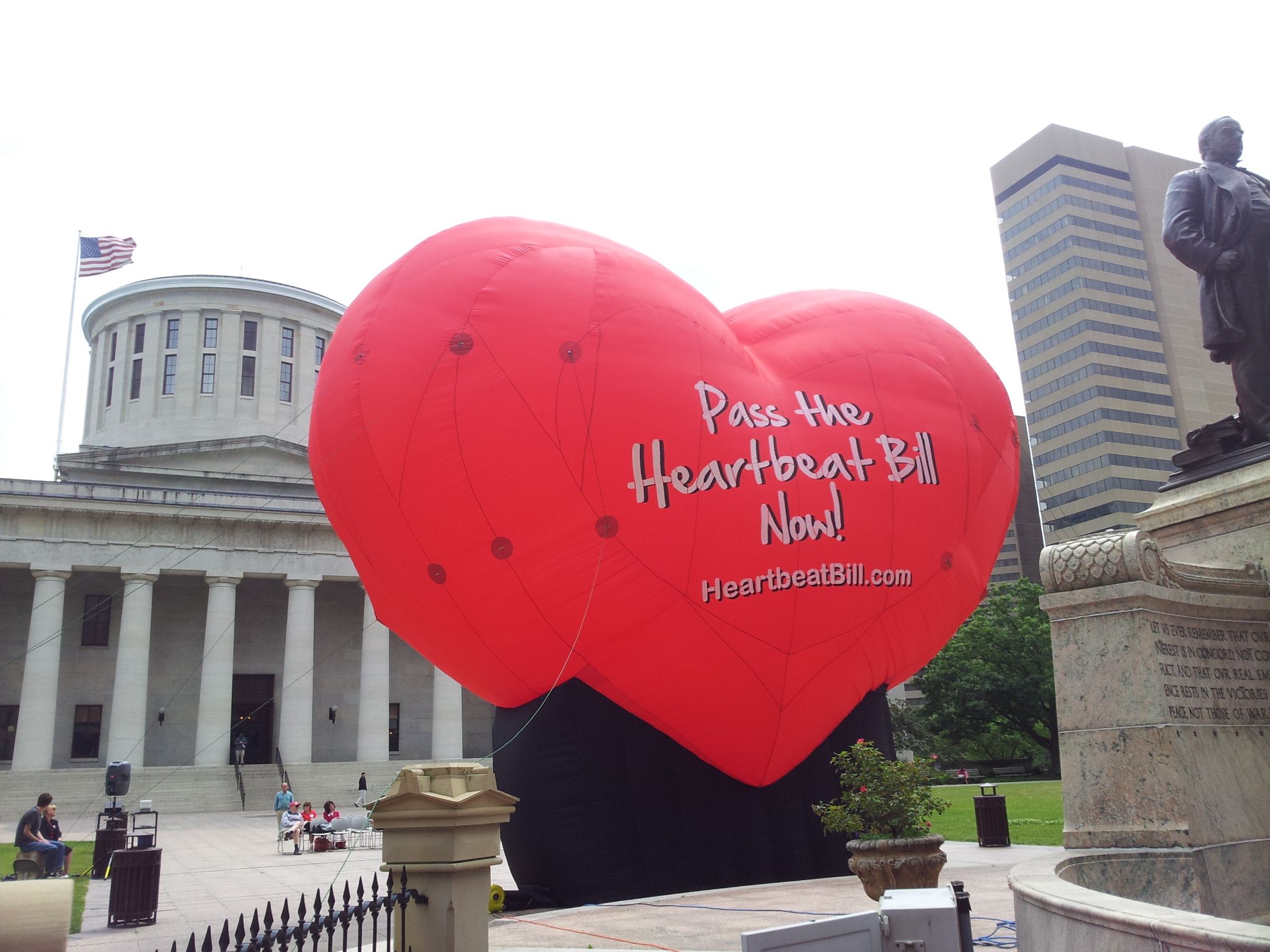 A huge red, heart-shaped balloon reading, "Pass the Heartbeat Bill Now!" stands outside the Ohio Statehouse in Columbus.