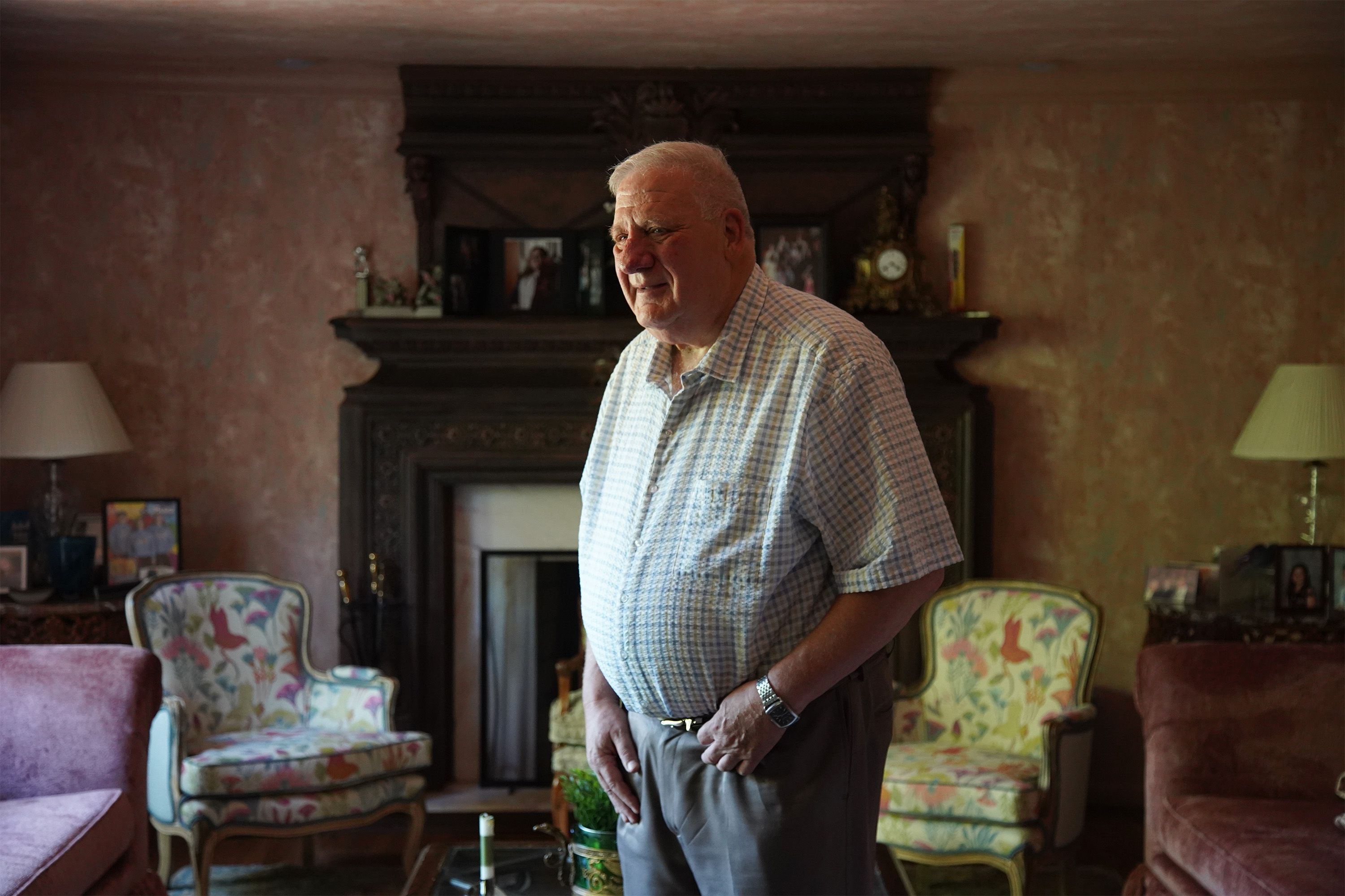 Dr. David Burkons stands in his living room.