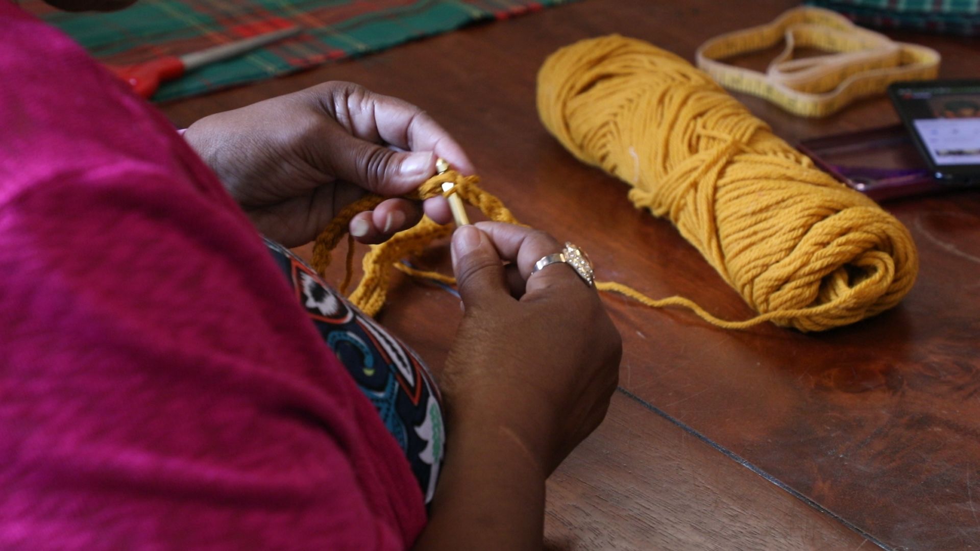 A woman knits during a program for older adults at the May Dugan Center. [Mary Fecteau / ideastream]