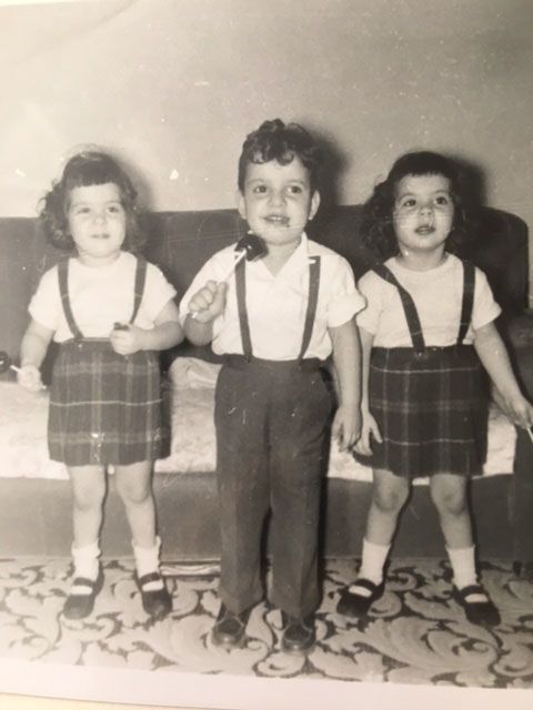 Lou Latona stands on the linoleum floor at his family's unit at Woodhill Homes, 1950s.