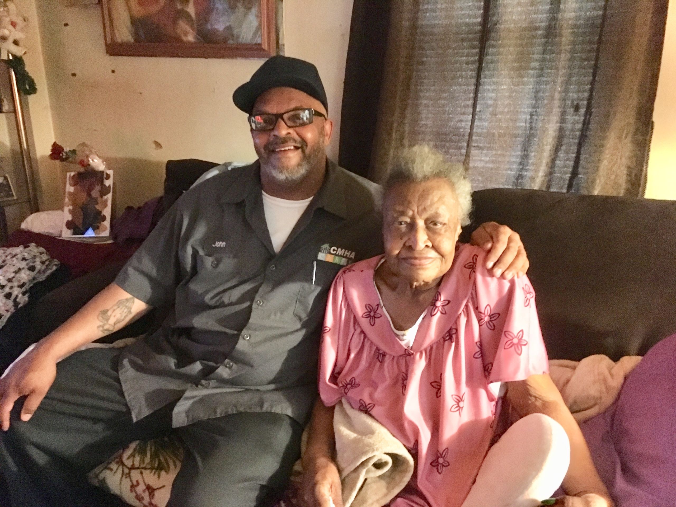 Resident Neola Jones sits with maintenance worker John Jackson.