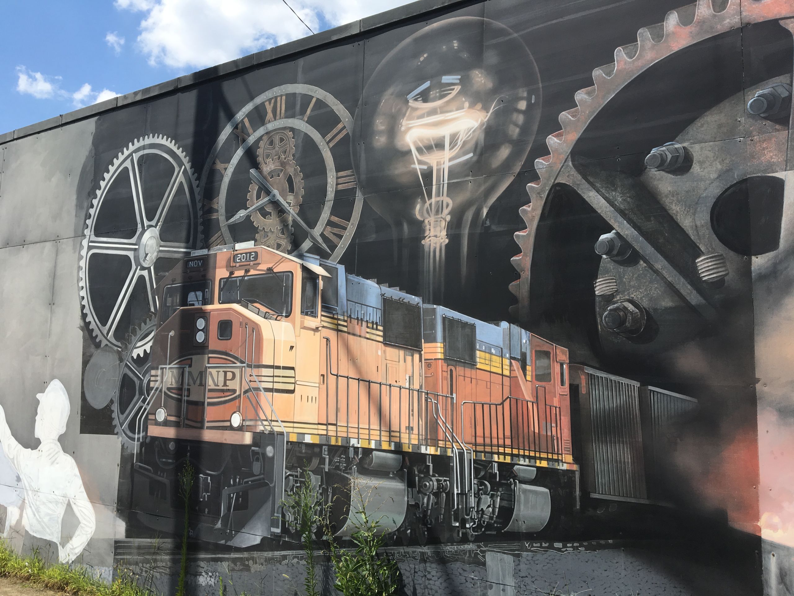 Rivera-Resto's tribute to Cleveland industry in Slavic Village includes workers, gears, light bulbs, trains and smokestacks.